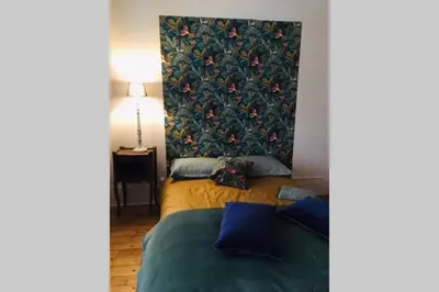 Un ou plusieurs lits dans un hébergement de l'établissement Chez Angèle Centre Mâcon appartement chaleureux