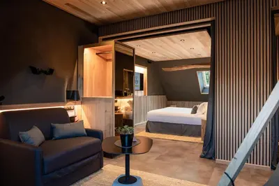 Un ou plusieurs lits dans un hébergement de l'établissement Le Studio des Prés Verts Suite Design avec Jacuzzi Privatif