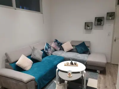 Coin salon dans l'établissement Appartement COSY et chaleureux