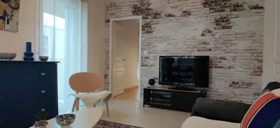 Télévision ou salle de divertissement dans l'établissement Le Mans'Art