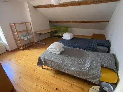 Un ou plusieurs lits dans un hébergement de l'établissement Gîte de la tour de Paradis