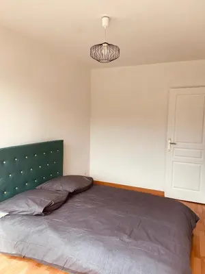 Un ou plusieurs lits dans un hébergement de l'établissement Appartement 2 chambres avec parking privé gratuit