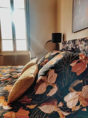 Un ou plusieurs lits dans un hébergement de l'établissement Gîte Les Roches : maison de caractère pour 15 personnes