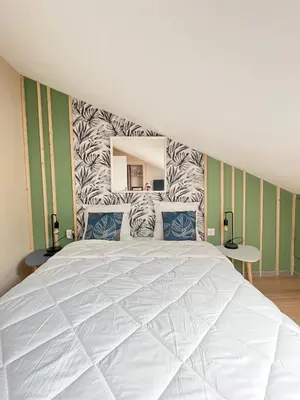 Un ou plusieurs lits dans un hébergement de l'établissement Charmant appartement proche du centre ville