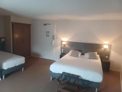 Un ou plusieurs lits dans un hébergement de l'établissement Hôtel La Parenthèse