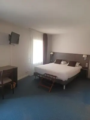 Un ou plusieurs lits dans un hébergement de l'établissement Hôtel La Parenthèse