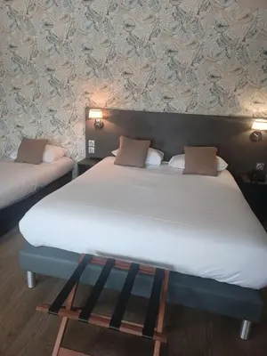 Un ou plusieurs lits dans un hébergement de l'établissement Hôtel La Parenthèse