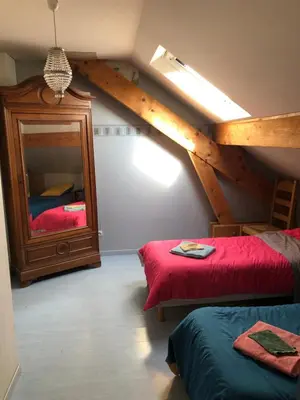 Un ou plusieurs lits dans un hébergement de l'établissement le p'tit studio au calme au pied du Jura