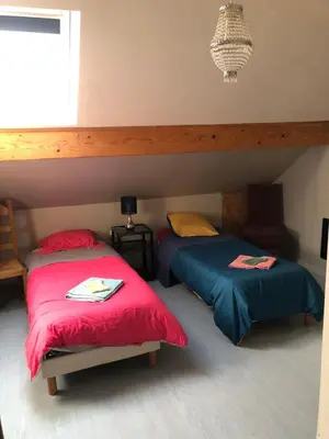 Un ou plusieurs lits dans un hébergement de l'établissement le p'tit studio au calme au pied du Jura